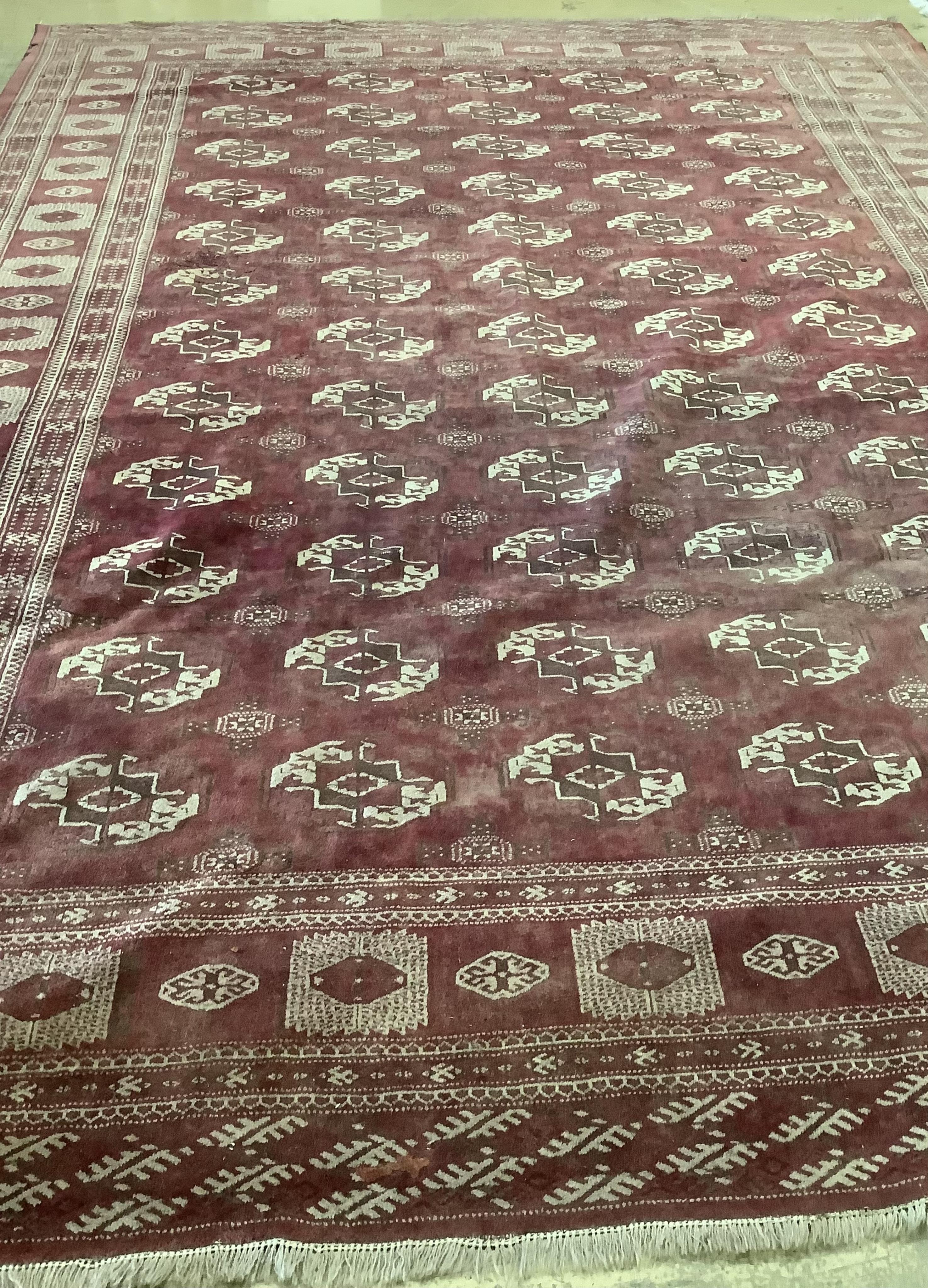 An antique Bokhara carpet, 384 x 286cm. Condition - fair